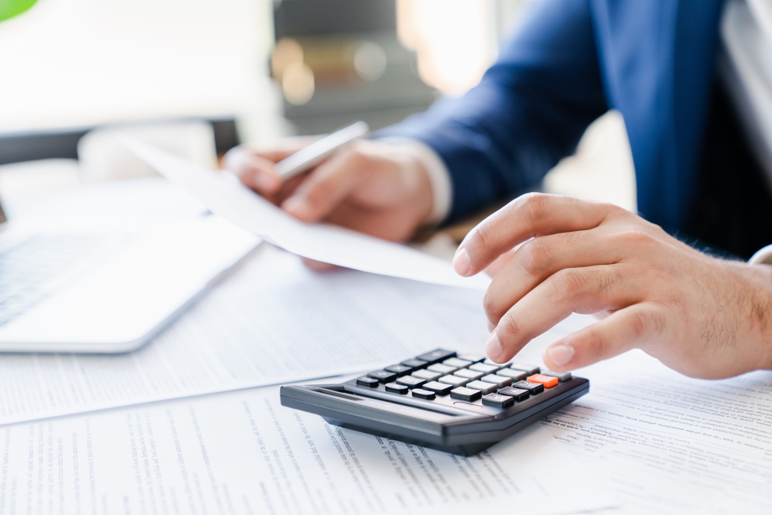 Man in business suit with calculator